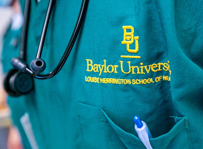 the logo of Baylor University school of nursing on a nursing scrub